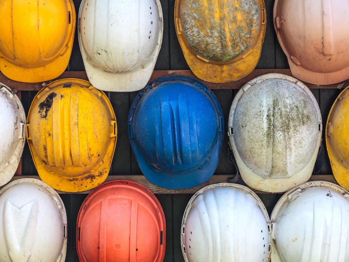 A collection of different colored hard hats seen from above