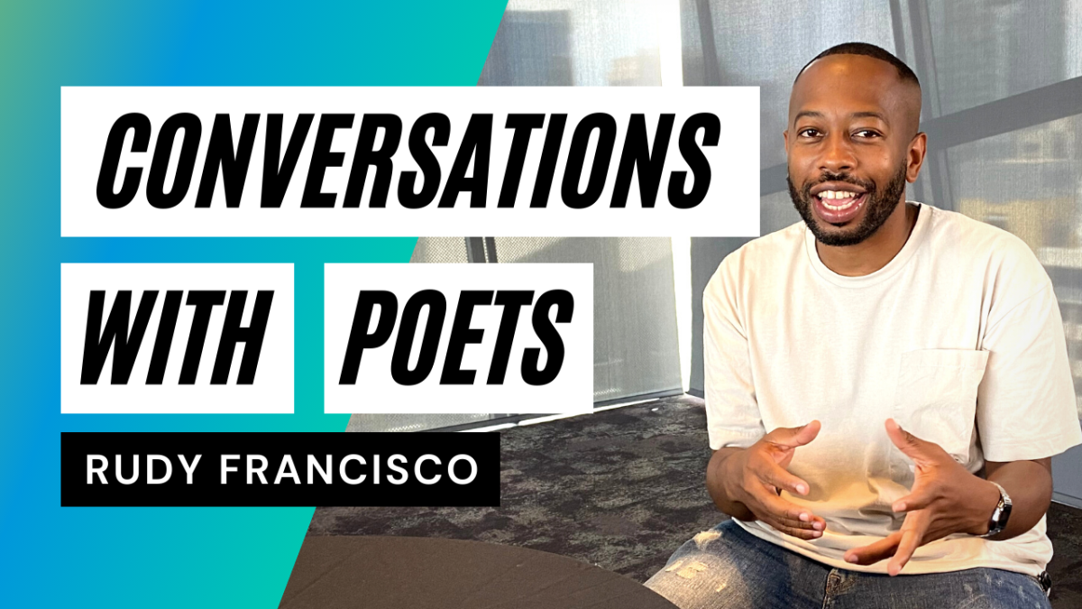 a young bearded man gestures with his hands inside Central Library’s Shiley Special Events Suite.