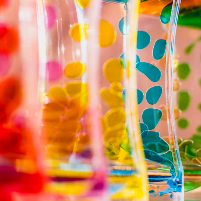 different colored oils float around in a glass lava lamp