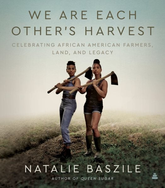 The cover features two women standing in a field, each holding a hoe over her shoulder. 