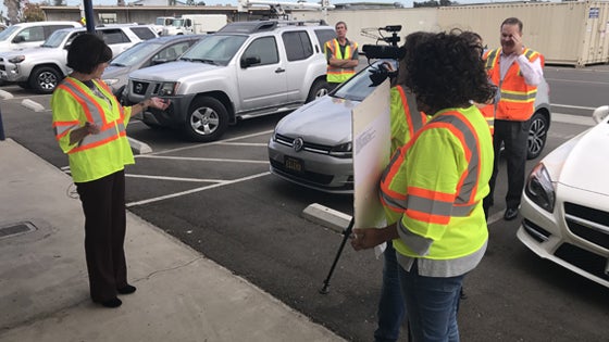 Camera recording employees with vests
