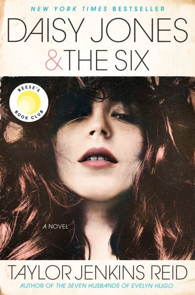 The cover features a young female with reddish brown hair looking down into the camera. 
