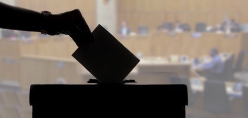 Ballot Card image of ballot being placed in ballot box
