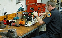 A firefighter repairing a small equipment.