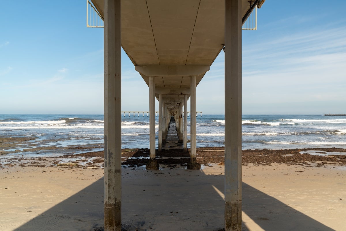 Ocean Beach Pier seen from underneath on the beach.