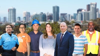 City employees in front of the San Diego downtown skyline