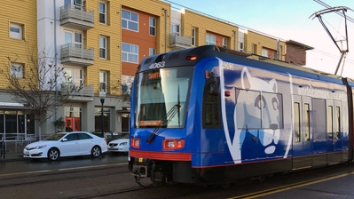San Diego Trolley passing by an apartment building