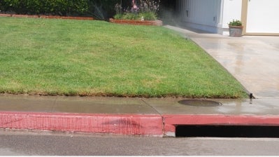 Lawn being watered by sprinklers