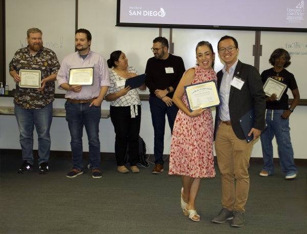 Woman poses with certificate