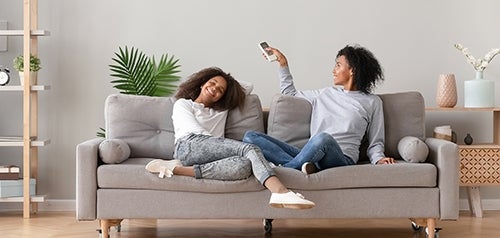 mother and daughter sitting in air conditioned room