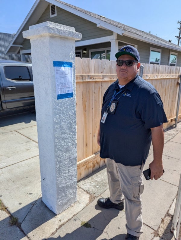 Code enforcement employee with a notice