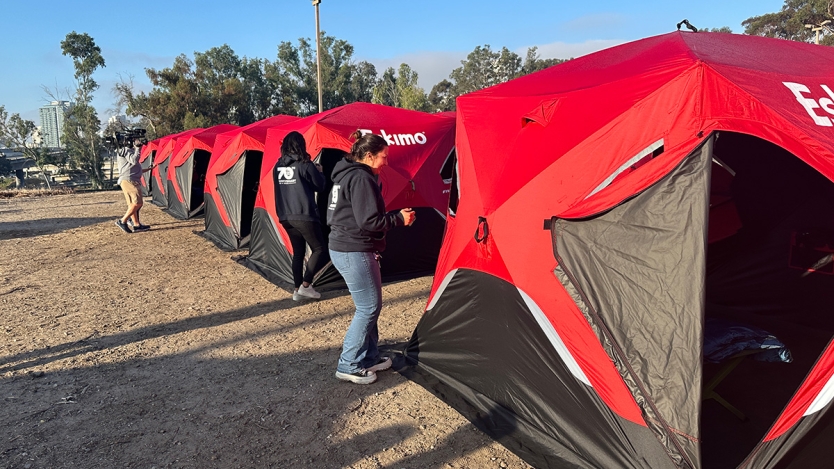 A row of tents lined up a safe sleeping site