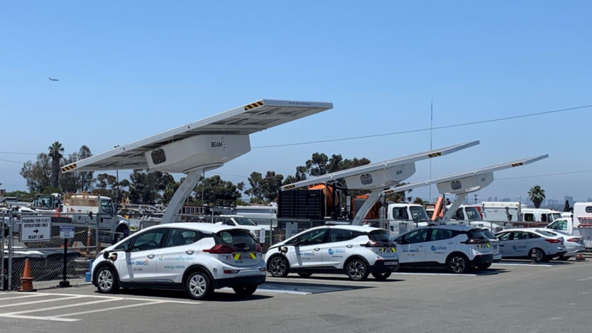 four green fleet cars in a parking lot