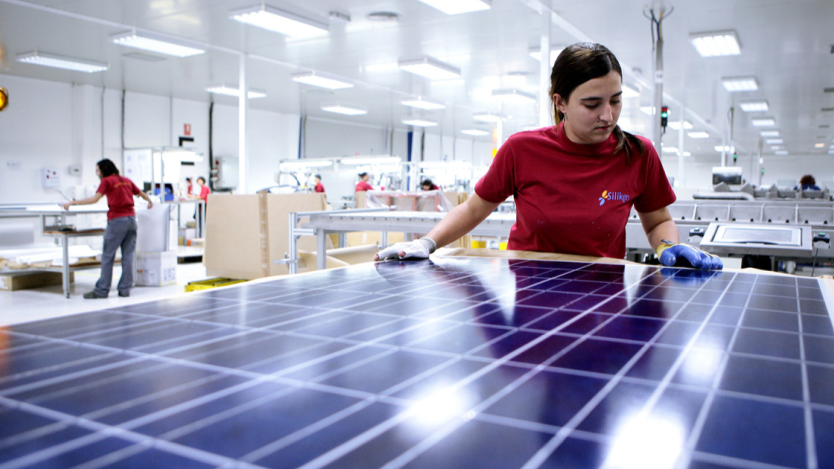 person in a lab working on solar panels