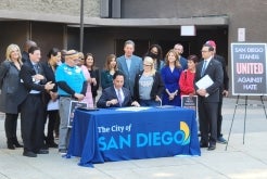 Group of people signing proclamation 