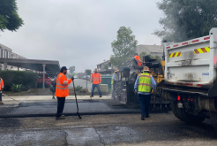 five transportation team members working on resurfacing road