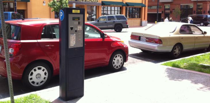 Photo of Parking Meter and Row of Parked Cars
