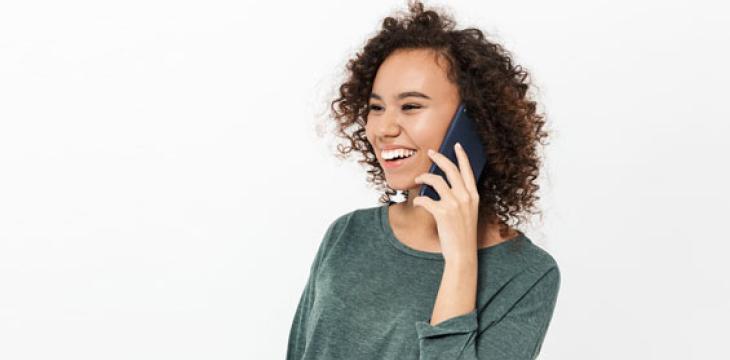 Senior asian woman talking phone while sitting in home living room