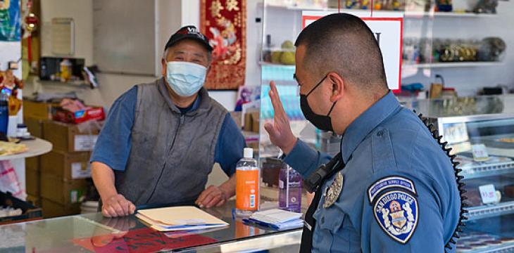 Police officer interacting with a business owner