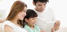 Asian family looking at tablet