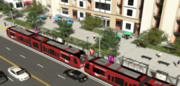 trolley on tracks next to mixed use building and roads
