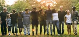 A line of diverse people standing shoulder to shoulder