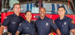 Photo of firefighters in front of firetruck