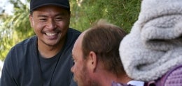 Outreach team member talking to a man experiencing homelessness