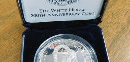Silver One Dollar in Blue Jewelry Box with Red white and Blue Stripes in left Corner