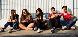 Group of social teenagers with smartphones