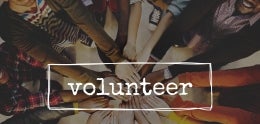 Photo of hands and the word Volunteer