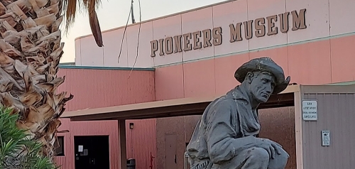 A statue of a pioneer in front of the Pioneers Museum