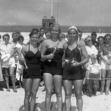 Three girls in black bathing suits