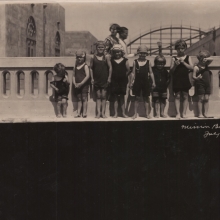 Eight young children at Mission Beach standing at seawall circa 1921