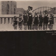 Eight young children at Mission Beach standing at seawall circa 1921