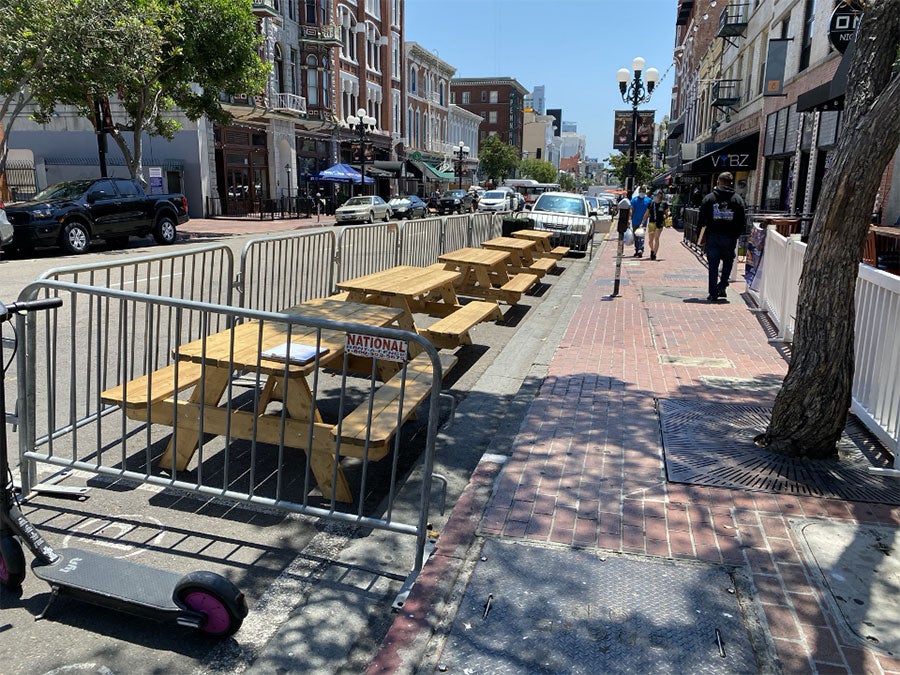 Dining tables placed on barricaded parking spaces