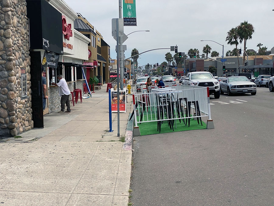 Dining tables placed on barricaded parking spaces