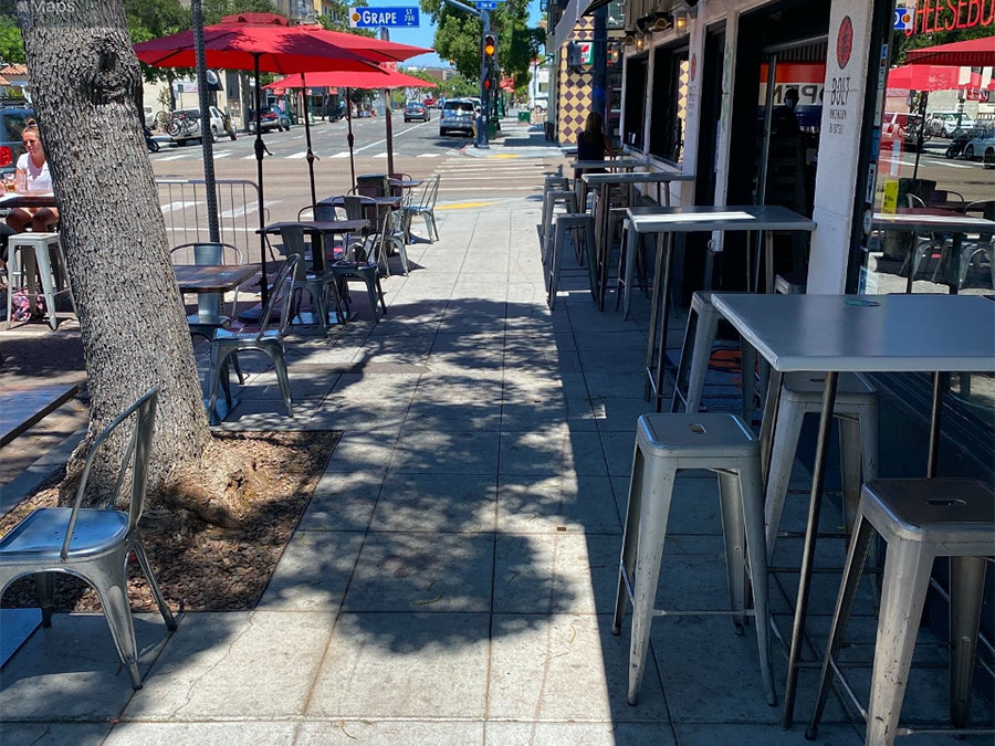 Dining tables placed on a sidewalk