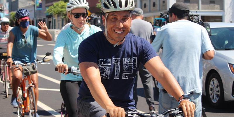 Mayor Todd Gloria riding a bike during the 30th Street Bikeway dedication