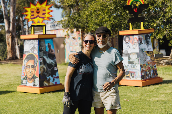 Sarah Bella Mondragon and Mario Torero standing in front of their Toltec Totems