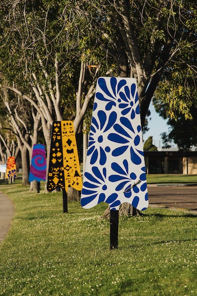Colorful artistic sculptures shaped like popsicles displayed at a park