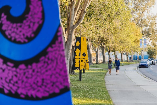 Colorful artistic sculptures shaped like popsicles displayed at a park