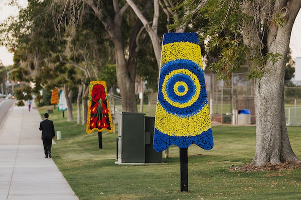 Colorful artistic sculptures shaped like popsicles displayed at a park