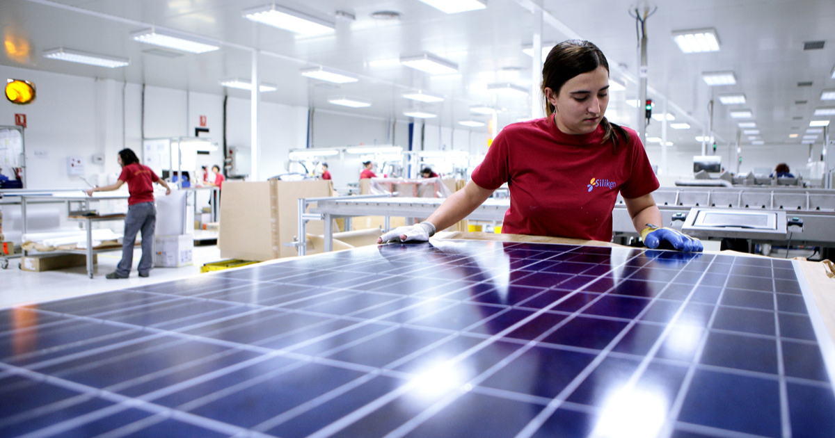 person in a lab working on solar panels