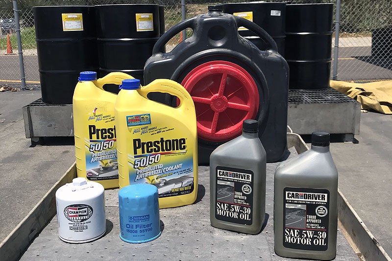 Close up of used engine oil in a Plastic canisters at the garage