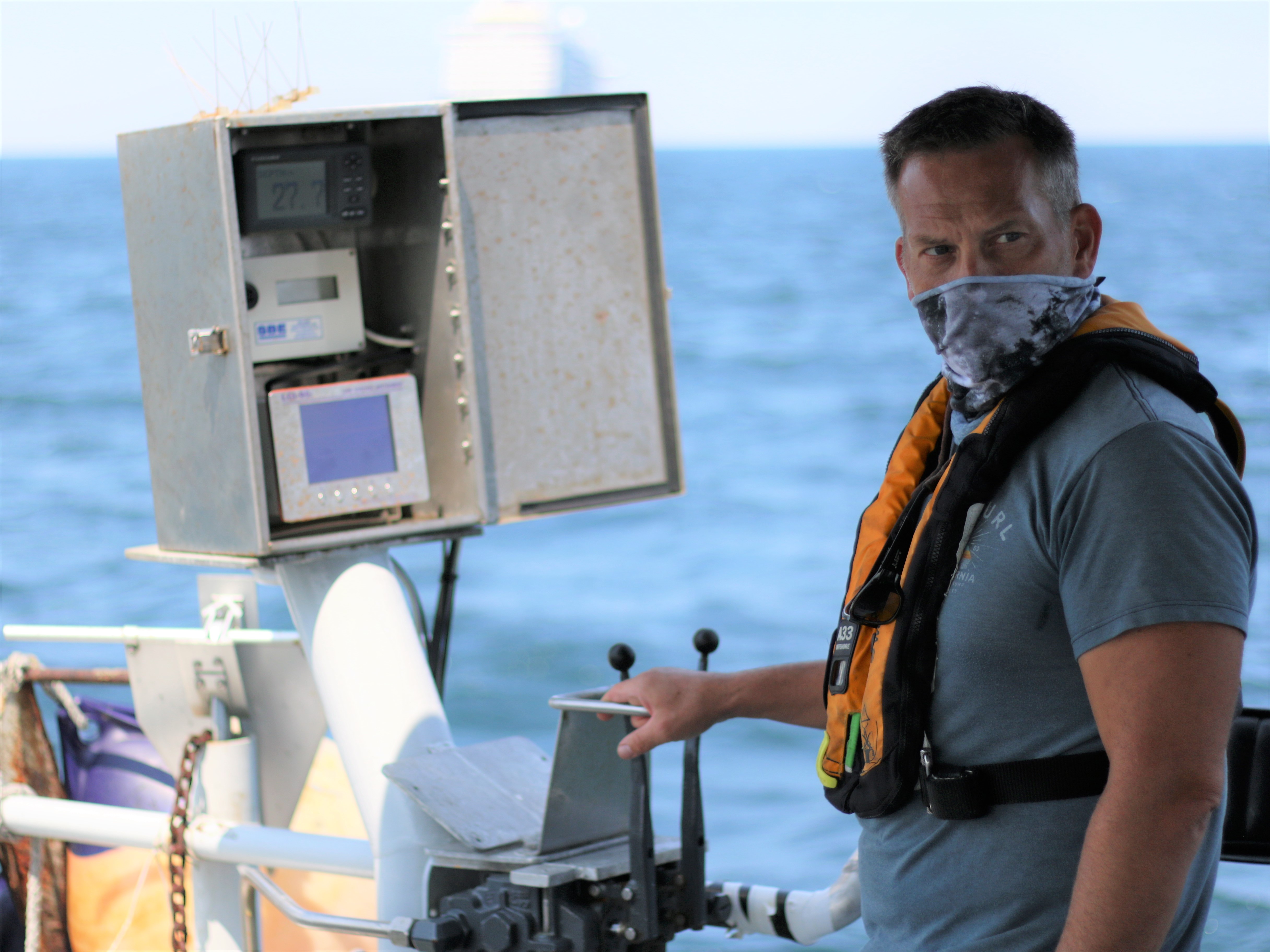 A marine biologist runs the winch, which raises and lowers oceanographic equipment from the stern of the vessel.